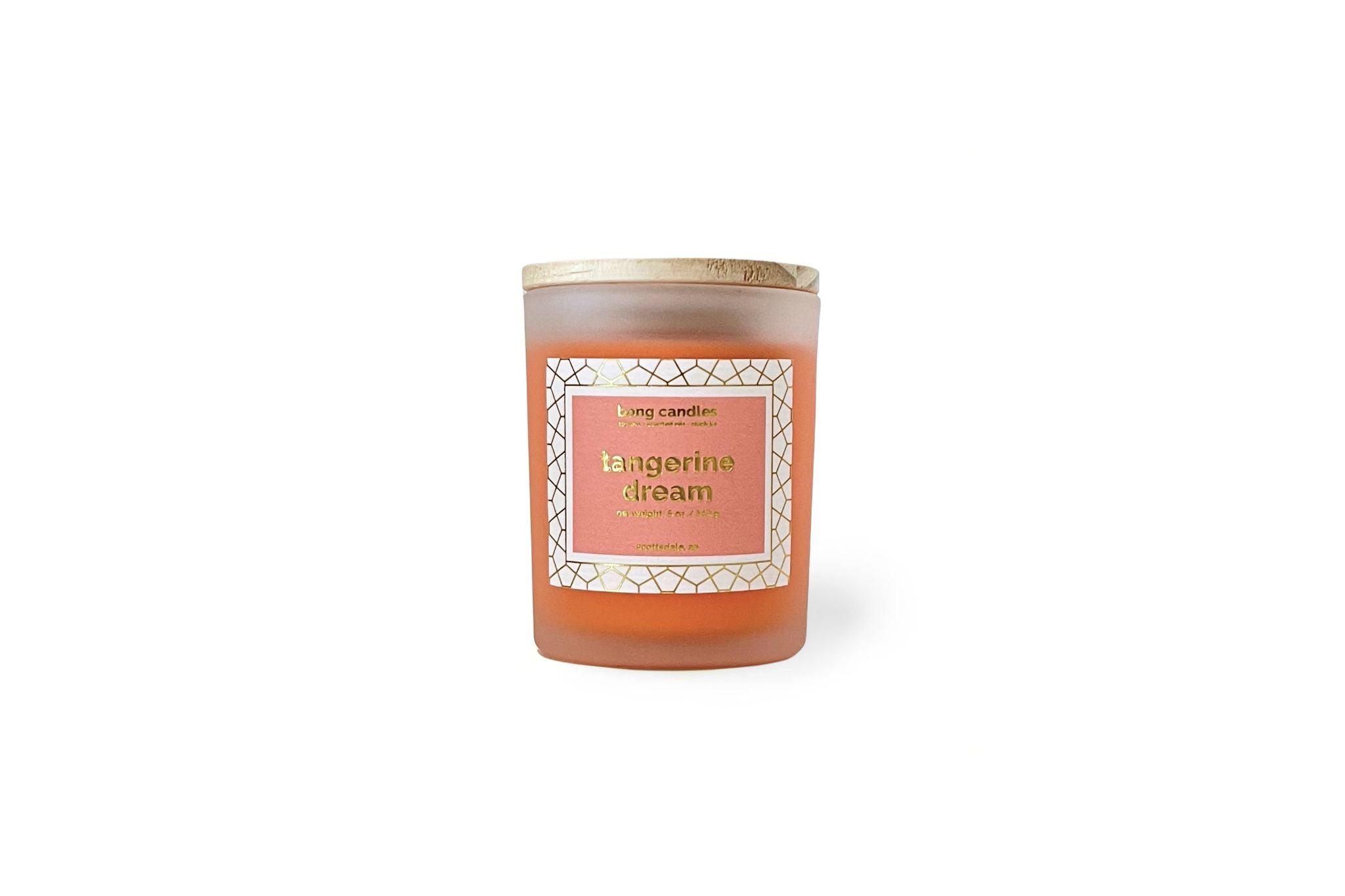 A tangerine pink soy wax candle inside a clear glass stash jar with a gold lid, labeled 'Tangerine Dream' with a decorative label.
