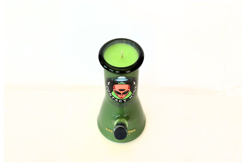 Green bong candle with a candle inside on a white background