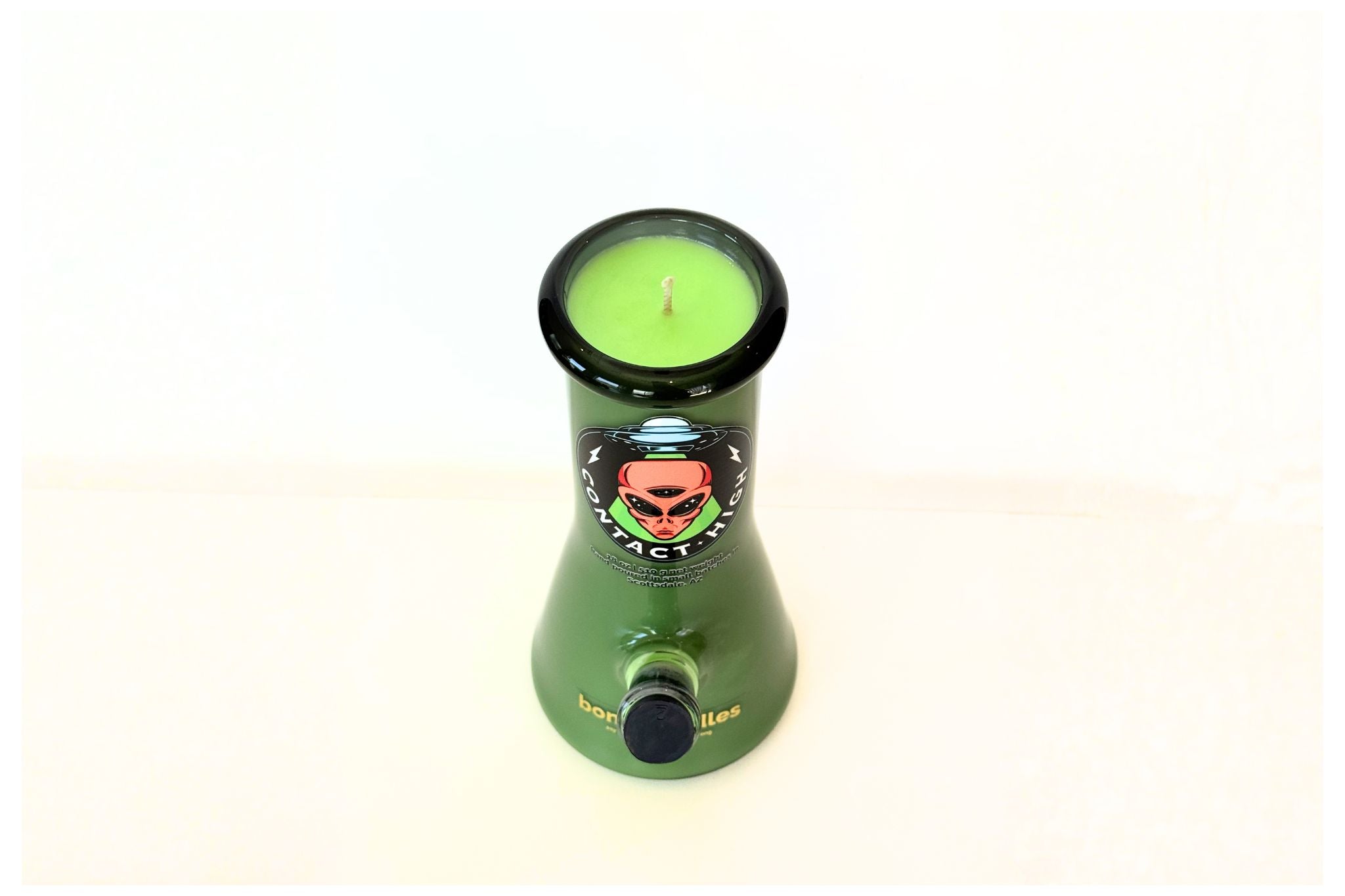 Green bong candle with a candle inside on a white background