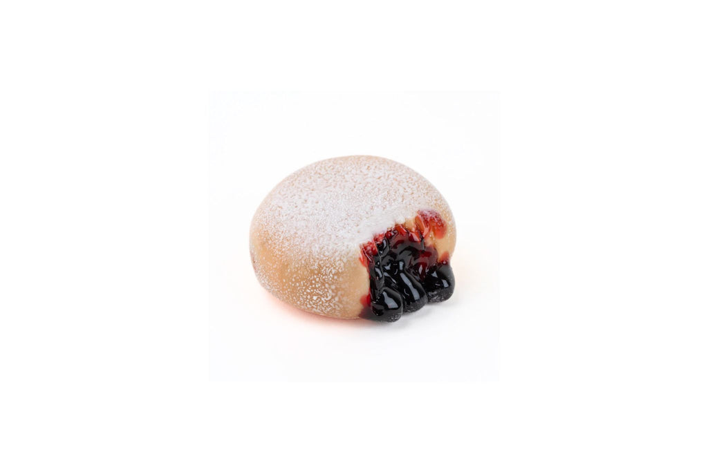 jelly roll donut shaped glass pipe with jam on top on a white background