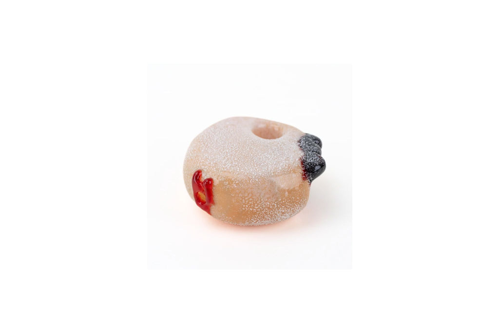 jelly roll donut shaped glass pipe with jam on top on a white background