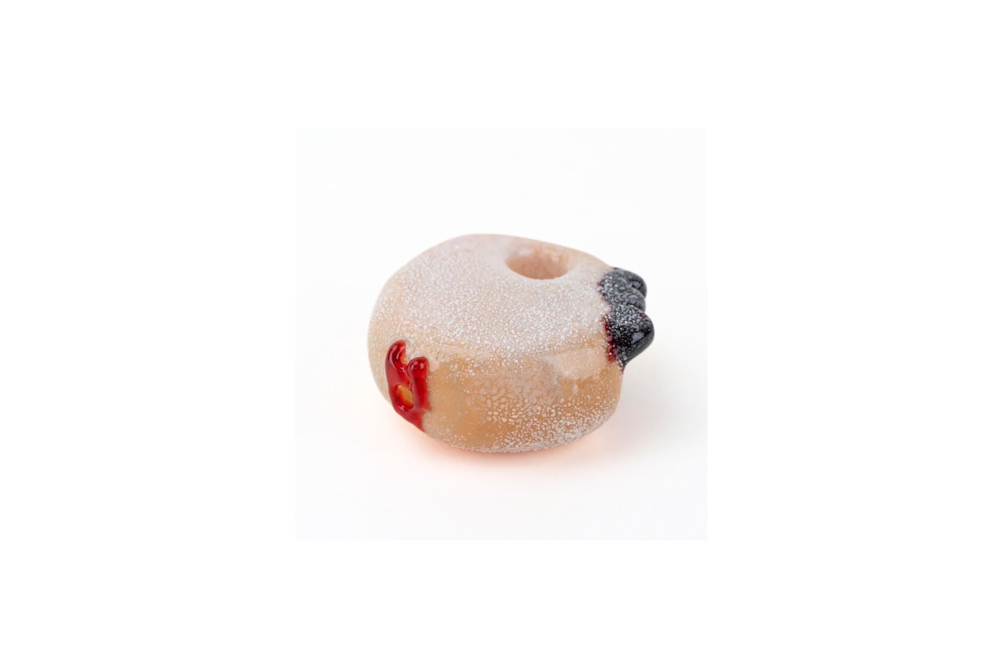 jelly roll donut shaped glass pipe with jam on top on a white background