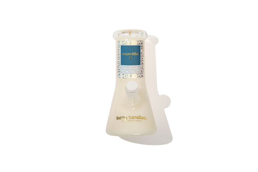manchild candle in a glass holder with a blue label on a white background